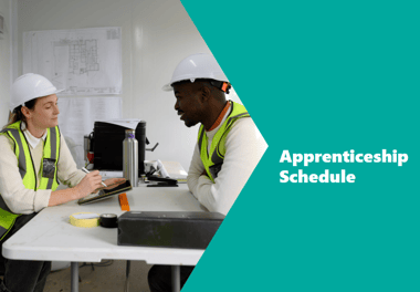 two construction workers on opposite sides of a desk discussing plans two construction workers on opposite sides of a desk discussing plans